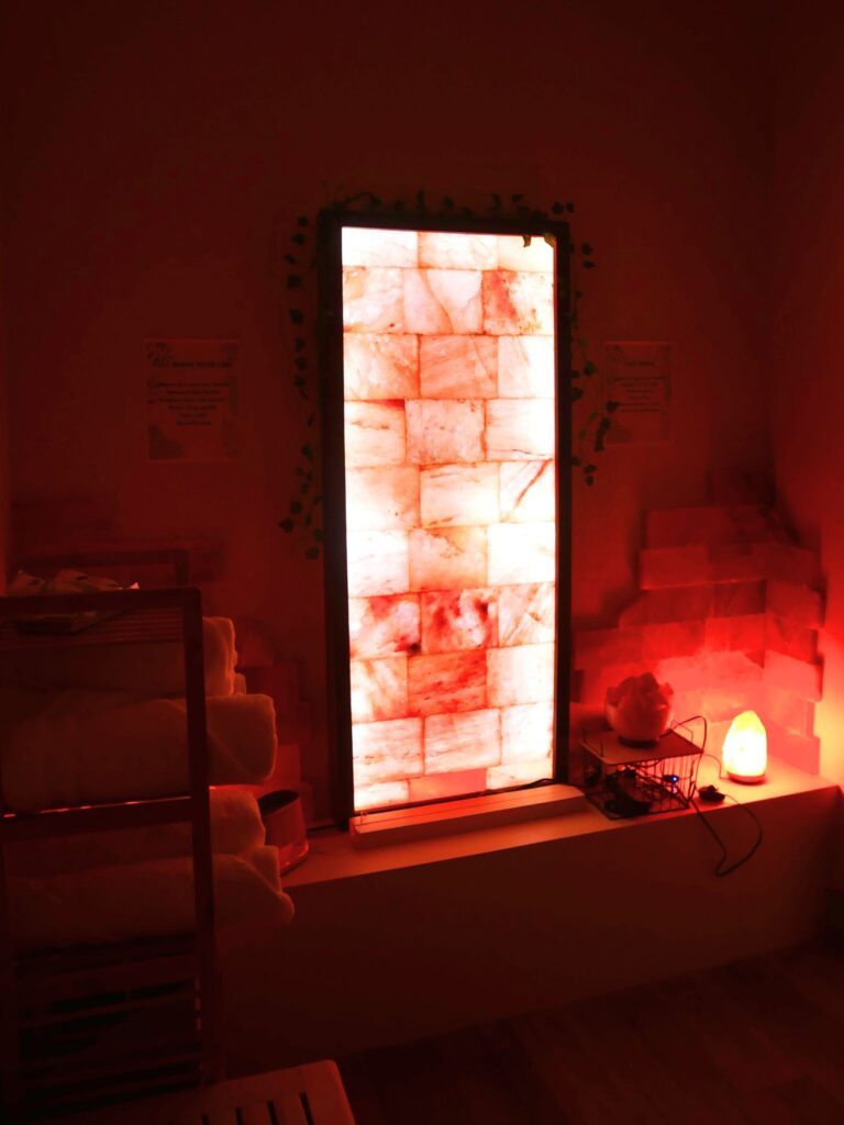 Peaceful salt therapy room with glowing Himalayan salt walls and warm lighting.
